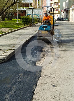 Worker on light vibration roller compactor