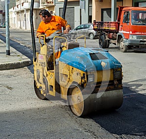 Worker on light vibration roller compactor