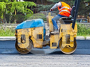 Worker on light vibration roller compactor