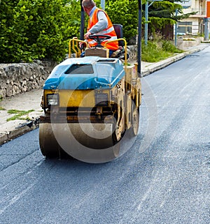 Worker on light vibration roller compactor