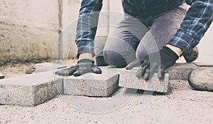 Worker lining paving slabs