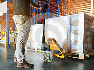 Worker loading cargo shipment pallet goods at warehouse storage.