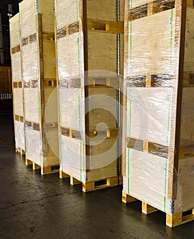 Worker loading and unloading shipment carton boxes and goods on wooden pallet by forklift from container truck to warehouse cargo