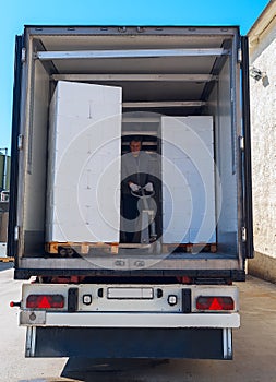 Worker loads semi-truck photo