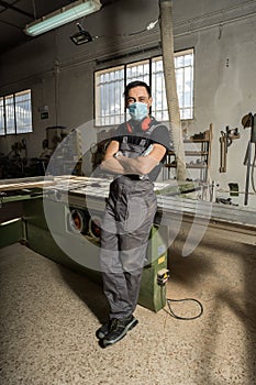 Worker looking at camera smiling in a factory