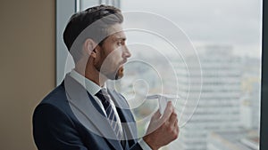 Worker looking paper airplane standing at window closeup. Man thinking on rest.