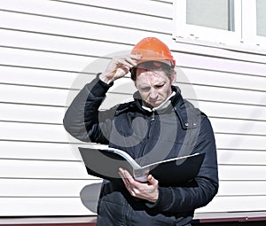 Worker looks at the drawing and compares the work done