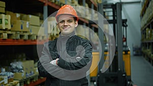 A worker looks intently into the camera. Then he smiles.