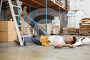 Worker lying on the floor in warehouse