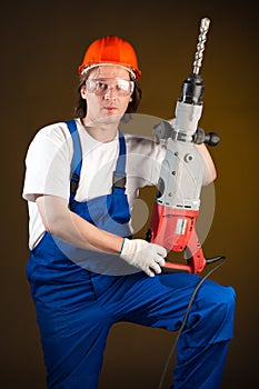 Worker with a machine drill
