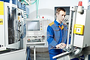 Worker at machine tool in workshop