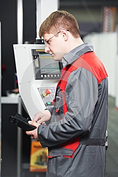 Worker at machining tool workshop