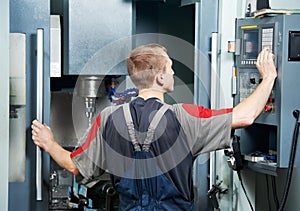 Worker at machining tool workshop