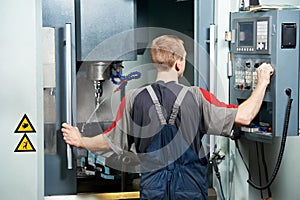Worker at machining tool workshop