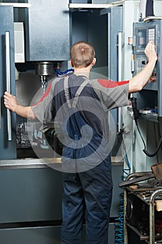 Worker at machining tool workshop