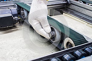 Worker maintenance and repair conveyor belt in factory