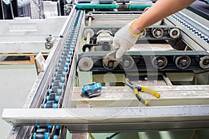 Worker maintenance and repair conveyor belt in factory