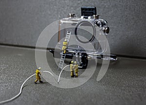 Worker in maintenance of an underwater action camera housing