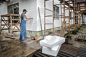 Worker makes building insulation saves energy with styrofoam