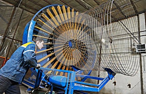 Worker making reinforcement for pipe