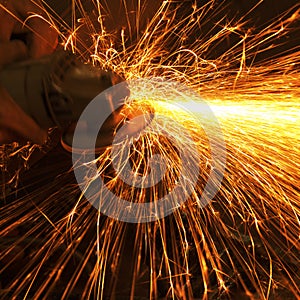 Worker making sparks while welding steel