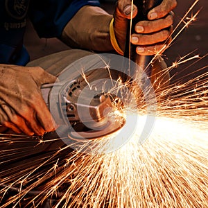 Worker making sparks while welding steel