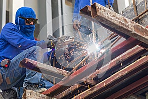 Worker making sparks from welding steel