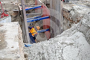 Worker making trench bed for new pipeline construction photo