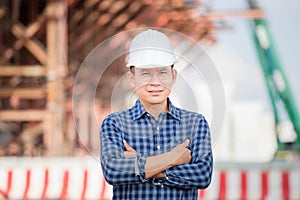 Worker man with arm crossed looking at camera, Engineer checking project at building site, Man in hardhat at infrastructure