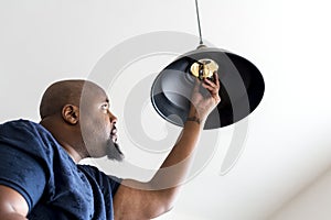 Worker Man changing light bulb