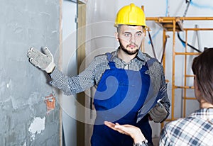 Worker man is clarifying details of work from client.