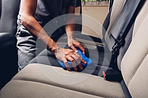 Worker man cleaning dust interior by cloth microfiber inside car