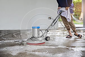 A worker man  cleaning and floor care by washing machine. outdoors. with copy space