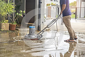 A worker man  cleaning and floor care by washing machine. outdoors. with copy space