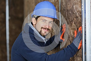 worker man insulates wall