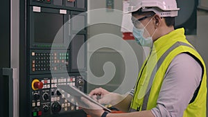 Worker man operating automated programming CNC milling control machine