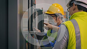 Worker man operating automated programming CNC milling control machine