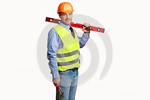 Worker Man Posing With Builder's Level Standing In Studio