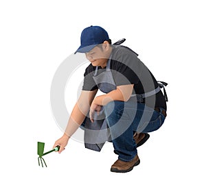 worker man or Serviceman in Black shirt and apron is holding Shovel for Cultivators isolated on white background
