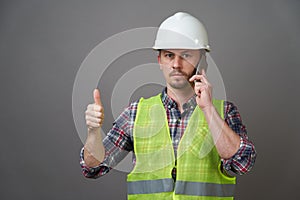 Worker man wearing protective hard hat and reflective vest