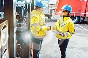 Worker and manager shaking hands at distribution center