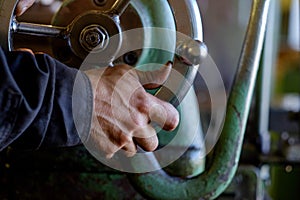 Worker manipulate old machine on factory