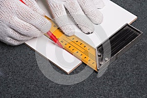 Worker marking a ceramic tile