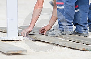 Worker marking plank for cutting