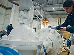 worker measures the thickness of the pipe. Checking the pipes at