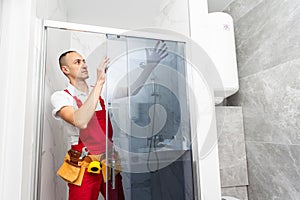 Worker measuring plastic window indoors. Installation process