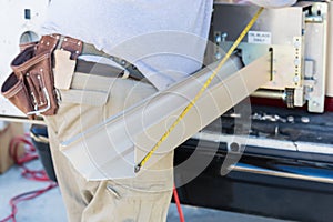 Worker Measuring Rain Gutter Processing Through Seamless Shaping