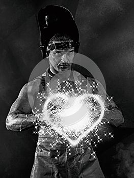 Worker men: blacksmith or welder with fireball like a heart