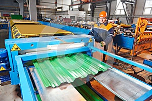 Worker at metal sheet profiling factory