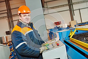 Worker at metal sheet profiling factory photo